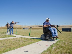 From left to right: OMRGC member Ben David reaches for a fresh shell while Hugh Bonertz aims down range and Dan Kuftinoff prepares for his shot on Saturday, Sept. 12. Below. A gun club member practices on the pistol range. John Stoesser photos/Pincher Creek Echo.