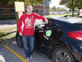 Fanshawe College's student union president Alan Bushell pose beside the school's new Zip Car in London, Ont. on Monday September 21, 2015. (DEREK RUTTAN, The London Free Press)