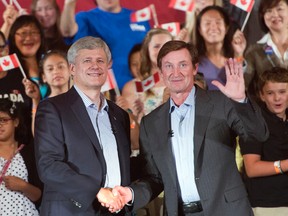 Conservative Leader Stephen Harper shakes hands with Wayne Gretzky during a campaign event in Toronto on Sept. 18, 2015. (THE CANADIAN PRESS)