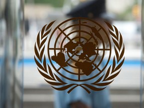 A security guard walks past the United Nations logo at the U.N. Headquarters in New York, August 31, 2013.    REUTERS/Carlo Allegri