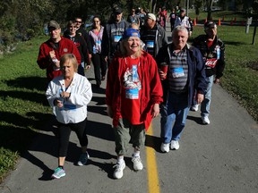 Cancer survivor Barb Lloyd of Belleville walks in the Belleville Terry Fox Run while surrounded by about 30 relatives Sunday. It marked the 35th anniversary of Fox's Marathon of Hope, which has raised millions of dollars for cancer research.