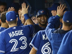 Edwin Encarnacion of the Toronto Blue Jays is congratulated by teammates after hitting a two-run home run against the Boston Red Sox at Rogers Centre in Toronto on Sept. 19, 2015. (Tom Szczerbowski/Getty Images/AFP)