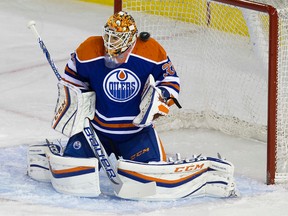 A Calgary Flames' shot goes over the shoulder of Edmonton Oilers' goalie Cam Talbot (33) and off the crossbar during first period NHL pre-season action at Rexall Place, in Edmonton Alta. on Monday Sept. 21, 2015. David Bloom/Edmonton Sun/Postmedia Network