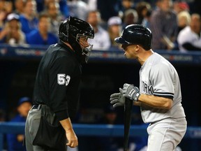 New York Yankees hitter Brett Gardner argues his strikeout with umpire Greg Gibson at Rogers Centre in Toronto Monday September 21, 2015. (Michael Peake/Toronto Sun/Postmedia Network)