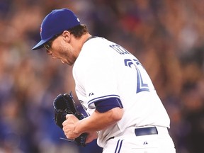 Blue Jays pitcher Brett Cecil celebrates after striking out three straight Yankees in the eighth inning on Monday night. (THE CANADIAN PRESS)