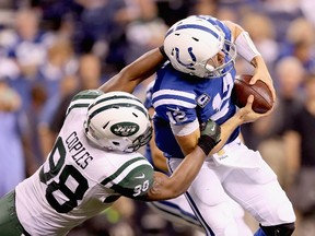 Indianapolis Colts quarterback Andrew Luck is sacked by New York jets defender Quinton Coples at Lucas Oil Stadium on September 21, 2015 in Indianapolis. (Andy Lyons/Getty Images/AFP)