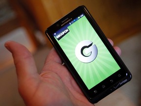 The Groupon smartphone app is displayed on a Motorola Droid Bionic cell phone in Denver in this file photo taken November 4, 2011. REUTERS/Rick Wilking/Files