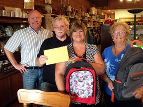 United Way's Terry Johnston, far left, and Brian Armitage accept a donation of 50 $10 grocery store gift cards from Re:Find's Valarie Kraayenbrink and Judy Vandendool. The gift cards went into some of the 110 backpacks that the Wallaceburg United Way office handed out as part of Operation Backpack. The backpacks also contained school supplies for students heading back to school. Re:Find is owned and operated by Wallaceburg Christian School. The shop is run by volunteers, with a portion of each month's sales donated to a local charity.