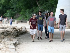 Pedestrians stroll down the riverwalk at The Forks earlier this year. The Forks is a popular meeting place for those with online dating profiles, according to Match. (Brian Donogh/Winnipeg Sun file photo)