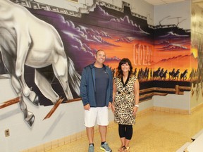 Sarnia airbrush artist Tim Allen and St. Clair Secondary School art teacher Angela Gardner stand in front of a new mural in the school's cafeteria. 
CARL HNATYSHYN/SARNIA THIS WEEK