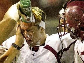 Angel Salazar of the La Canada high school football team has his face washed by a team trainer following an ugly incident in Los Angeles on Sept. 4. (Paul Chamberlain/La Cañada High)