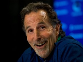 In this April 14, 2014 file photo, Vancouver Canucks' head coach John Tortorella laughs after a reporter mistakenly called him Mike during an end of season news conference in Vancouver. (AP Photo/The Canadian Press, Darryl Dyck)