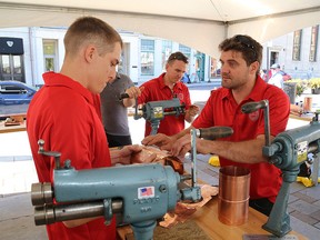 Matthew Serson, left, of Kingston and Nathan WiWaddick, of Chatham, take part in The Ontario Sheet Metal Apprenticeship Competition in Springer Market Square in Kingston last week. Ian MacAlpine/Whig-Standard file photo)