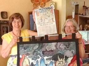 Local artist Jillian Gilliland, left, in Kingston on Tuesday, stands next to Carol Collins of Burlington, who made the rug hooking they are holding based on one of Gilliland's illustrations, called The Dragon's Pearl. The rug took Collins two years to make. (Supplied photo)