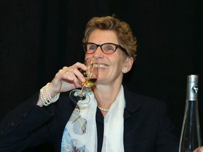 Premier Kathleen Wynne pours ice wine during a press conference at the Queen's Quay LCBO in Toronto January 15, 2014. (Veronica Henri/Toronto Sun)