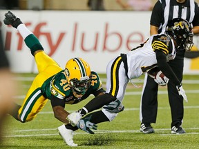 Deon Lacey, shown here tackling Hamilton kick returner Brandon Banks earlier this season, added two sacks and three tackles to his season total against the Ticats on Saturday. (Perry Nelson, Edmonton Sun)