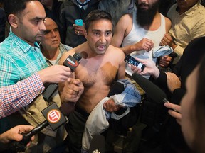 Salwinder Dhatt (no shirt) and taxi drivers erupt in anger as City Council discusses a ride service bylaw, in Edmonton Alta. on Tuesday Sept. 22, 2015. David Bloom/Edmonton Sun
