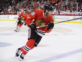 Chicago Blackhawks right wing Patrick Kane chases the puck against the Detroit Red Wings in their pre-season game in Chicago Tuesday, Sept. 22, 2015. (AP Photo/David Banks)