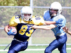 Noah Stargratt of the St. Benedict Bears tries to take down Anthony Thomas of the College Notre Dame Alouettes during senior boys high school football from James Jerome Feild in Sudbury, Ont. on Tuesday September 22, 2015. Gino Donato/Sudbury Star/Postmedia Network