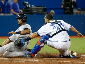 Toronto Blue Jays catcher Dioner Navarro tags out New York Yankees baserunner Chris Young in the ninth inning Monday September 21, 2015 at the Rogers Centre. (Michael Peake/Toronto Sun/Postmedia Network)