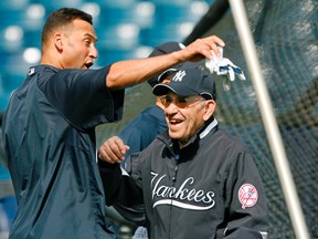 This March 7, 2008, file photo shows New York Yankees shortstop Derek Jeter, left, and Yogi Berra clowning around by the batting cage before the Yankees spring training baseball game against the Houston Astros at Legends Field in Tampa. Berra, the Yankees Hall of Fame catcher, has died. He was 90. (AP Photo/Kathy Willens, File)