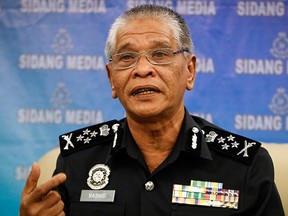Malaysian police Deputy Inspector Gen. Noor Rashid Ibrahim gestures as he speaks during a press conference at the police headquarters in Kuala Lumpur, Malaysia Wednesday, Sept. 23, 2015. (AP Photo/Joshua Paul)