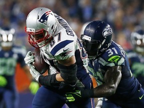 Rob Gronkowski #87 of the New England Patriots makes a catch against Kam Chancellor #31 of the Seattle Seahawks in the fourth quarter during Super Bowl XLIX at University of Phoenix Stadium on February 1, 2015 in Glendale, Arizona.   Tom Pennington/Getty Images/AFP