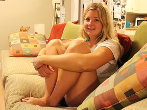 Erin Dryburgh, sits in her Sarnia apartment, drawing in her legs so she doesn't feel pain from interstycial cystitis. The 28-year old is spreading awareness about the bladder disease during September. Tyler Kula/Sarnia Observer/Postmedia Network