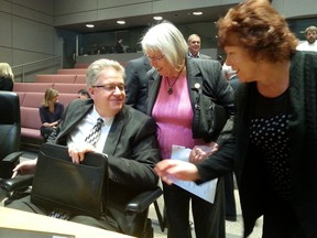 City manager Kent Kirkpatrick receives well-wishes from councillors Marianne Wilkinson and Jan Harder after council on Wednesday, Sept. 25, 2015 after he announced he will retire. (JON WILLING Ottawa Sun / Postmedia Network)