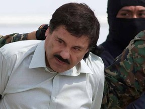 This Feb. 22, 2014 file photo shows Joaquin "El Chapo" Guzman, the head of Mexico’s Sinaloa Cartel, being escorted to a helicopter in Mexico City following his capture overnight in the beach resort town of Mazatlan. A judge in Mexico has issued a second arrest warrant to detain escaped drug lord Joaquin "El Chapo" Guzman based on an extradition request from the United States. The federal prosecutors’ office said Wednesday, Sept. 23, 2015 the new warrant is for U.S. charges of organized crime, money laundering drug trafficking, homicide and others. Guzman escaped on July 11, 2015 through a tunnel from Mexico's highest-security prison. (AP Photo/Eduardo Verdugo, File)
