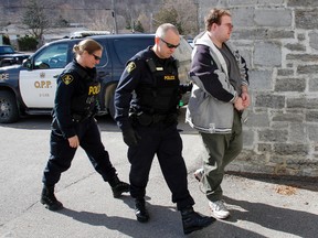Intelligencer FILE PHOTO
James Beau Jeffery is escorted inside a Picton Courthouse by OPP officers April 17, 2014. Jeffery has recently been granted community privileges.