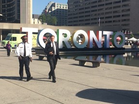 Toronto Police Chief Mark Saunders and Mayor John Tory in Nathan Phillips Square on Sept. 23, 2015. (Don Peat/Toronto Sun)