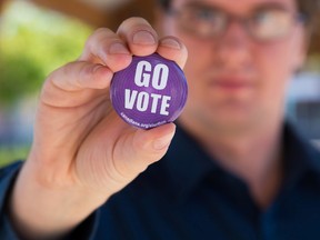 TIM MILLER/THE INTELLIGENCER
Richard Hewitt, spokesperson for the Council of Canadians, holds up a pin urging people to 'Go Vote' in Belleville. The council is a social action organization who have just recently opened a chapter in the Bay of Quinte area.