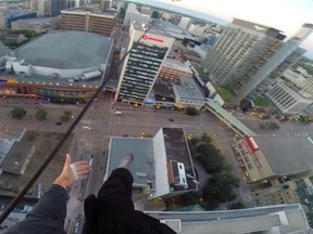 A man climbed a crane and dangled from it in a daring video posted on YouTube. (YOUTUBE SCREEN GRAB)