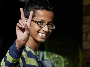 In this Sept. 17, 2015, file photo, Ahmed Mohamed gestures as he arrives to his family's home in Irving, Texas. The family of the 14-year-old Muslim boy who got in trouble over a homemade clock mistaken for a possible bomb has withdrawn the boy from his suburban Dallas high school Monday, Sept. 21. (AP Photo/LM Otero, File)