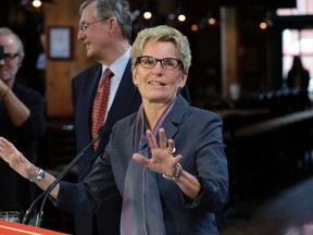Premier Kathleen Wynne says beer will be in grocery stores by Christmas at an announcement on Sept. 23, 2015. (Craig Robertson/Toronto Sun)