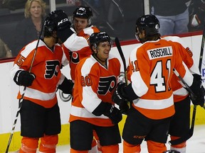 Philadelphia Flyers center Travis Konecny (80) celebrates his second period goal with teammates defenseman Michael Del Zotto (15), defenseman Yevgeni Medvedev (82) of Russia and left winger Jay Rosehill (41) during an NHL preseason hockey game against the New York Islanders in Allentown, Pa., Monday, Sept. 21, 2015. (AP Photo/Rich Schultz)