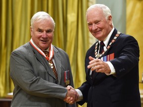 Gov. Gen. David Johnston promotes longtime Kingston and Islands member of Parliament and Speaker of the House of Commons Peter Milliken to an Officer of The Order of Canada to during an investiture ceremony at Rideau Hall in Ottawa on Wednesday. (THE CANADIAN PRESS/Sean Kilpatrick)