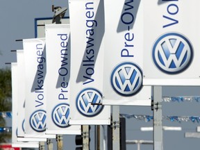 Signs hang from light poles at a Volkswagen car dealership in San Diego, California September 23, 2015. Volkswagen Chief Executive Martin Winterkorn resigned on Wednesday, succumbing to pressure for change at the German carmaker, which is reeling from the admission that it deceived U.S. regulators about how much its diesel cars pollute.  REUTERS/Mike Blake