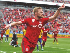 Toronto FC defender Damien Perquis celebrates after scoring against Colorado on Saturday. (USA TODAY SPORTS)