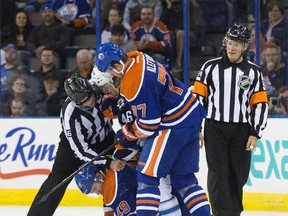 Winnipeg Jets' J.C. Lipon gets in a scuffle with Oilers' Justin Schultz and Oscar Klefbom during first period NHL pre-season action in Edmonton. (The Canadian Press)