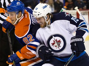 The Oilers' Jordan Oesterle battles the Jets' Matt Halischuk. (David Bloom/Postmedia Network)