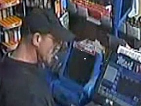 Police are asking the public for help identifying a Jekyll and Hyde robbery suspect who turned suddenly from "a normal customer" to a gun-toting thief during a McArthur Ave., store robbery. (Submitted image Ottawa Police / Postmedia Network).