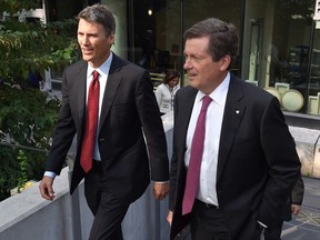 Toronto Mayor John Tory (right) and Vancouver Mayor Gregor Robertson arrive for a news conference at the big city mayors' conference in Toronto, Thursday, Sept.24, 2015. THE CANADIAN PRESS/Frank Gunn