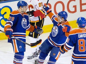 The Edmonton Oilers' Leon Draisaitl (29), Nail Yakupov (10), and Brandon Davidson (88) celebrate Draisaitl's goal against the Calgary Flames during third period NHL pre-season action at Rexall Place, in Edmonton Alta. on Monday Sept. 21, 2015. Edmonton won 4-2. David Bloom/Edmonton Sun/Postmedia Network