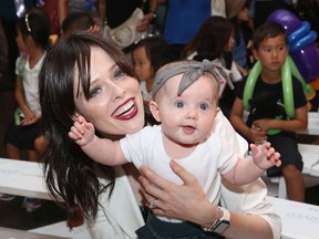 Model Coco Rocha with daughter Ioni James Conran attend Paul Frank Industries Kid's Show Front Row during Spring 2016 New York Fashion Week at Hudson Mercantile on September 10, 2015 in New York City.  Robin Marchant/Getty Images/AFP