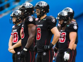 Ottawa RedBlacks' Antoine Pruneau, centre, looks on as his team plays the Toronto Argonauts during the second half of CFL football action in Toronto on Sunday, August 23, 2015. THE CANADIAN PRESS/Mark Blinch