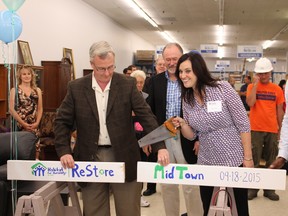Mayor John Henry and MPP Jennifer French help officially open the new Habitat-Durham Restore at the Midtown Mall in Oshawa on Sept. 18, while attendees look on.