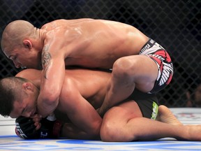 Zhang Lipeng and Kajan Johnson (top) fight on the mat during their UFC lightweight bout in Manila May 16, 2015. (REUTERS/Romeo Ranoco)