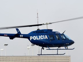A Mexican police helicopter. AFP PHOTO/RONALDO SCHEMIDT